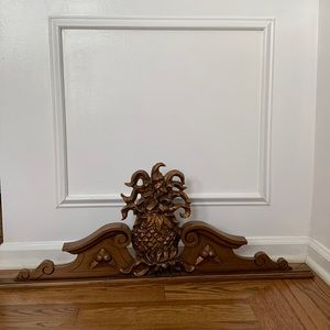 Solid wood with gold finish pineapple plaque. Beautiful over a doorway.